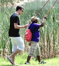 Adult male and boy going fishing together.