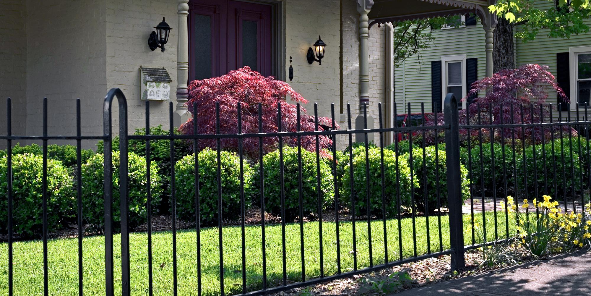 Cutting grass against online fence